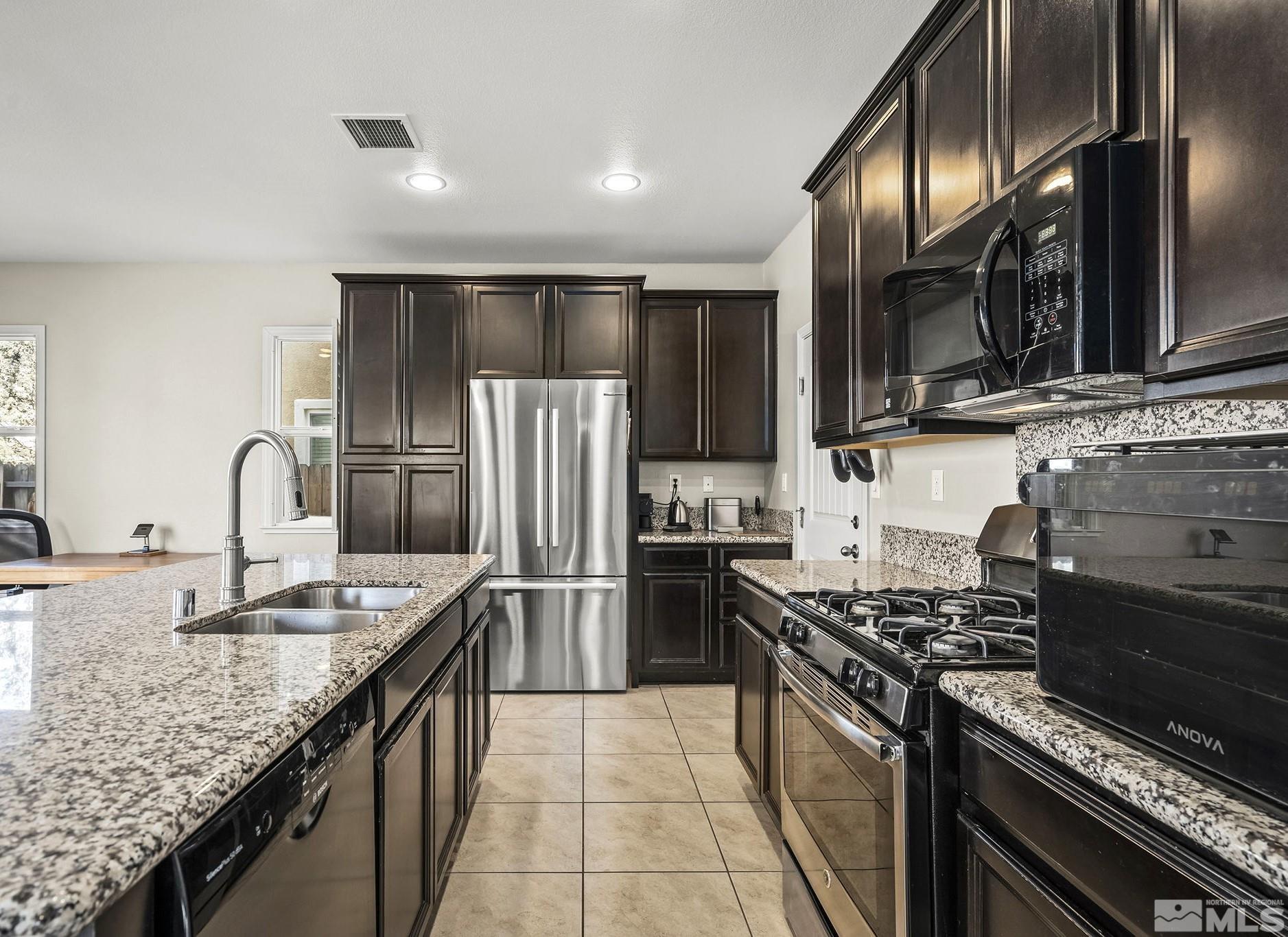 2055 Hope Valley Drive Reno, NV 89521 - Photo 3 of 21 a kitchen with stainless steel appliances granite countertop a sink stove and refrigerator