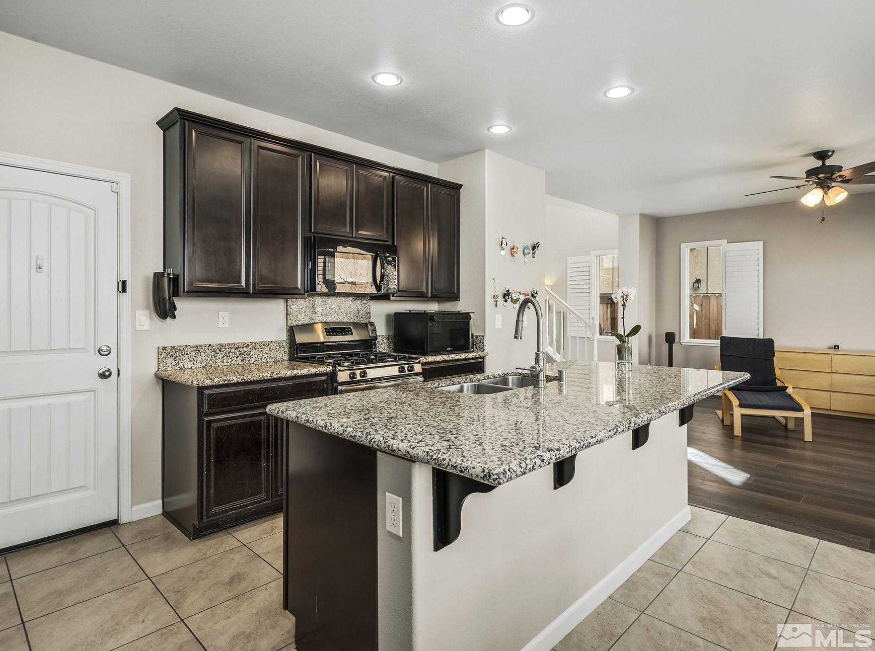 2055 Hope Valley Drive Reno, NV 89521 - Photo 4 of 21 a kitchen with kitchen island granite countertop a stove and cabinets