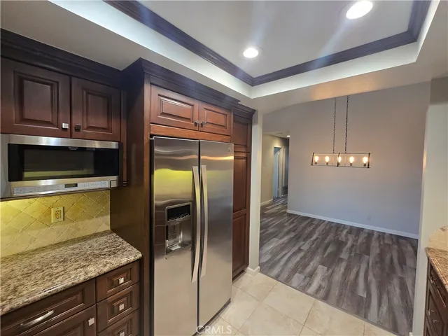 a kitchen with a refrigerator and microwave