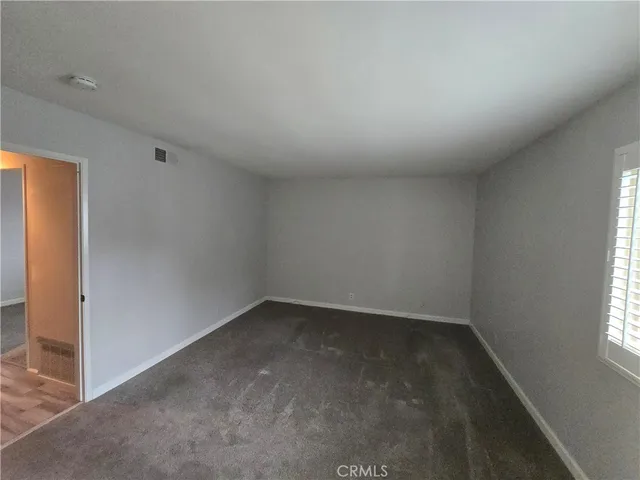 an empty room with a empty space and windows