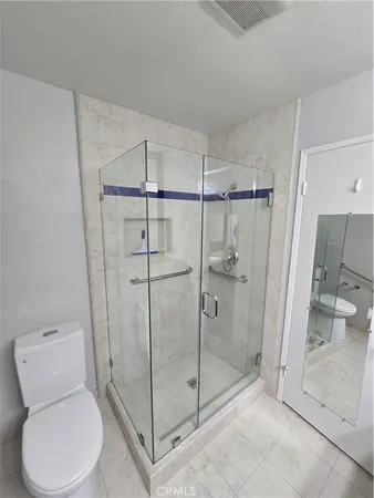 a bathroom with a toilet and shower