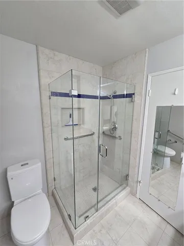 a bathroom with a toilet and shower