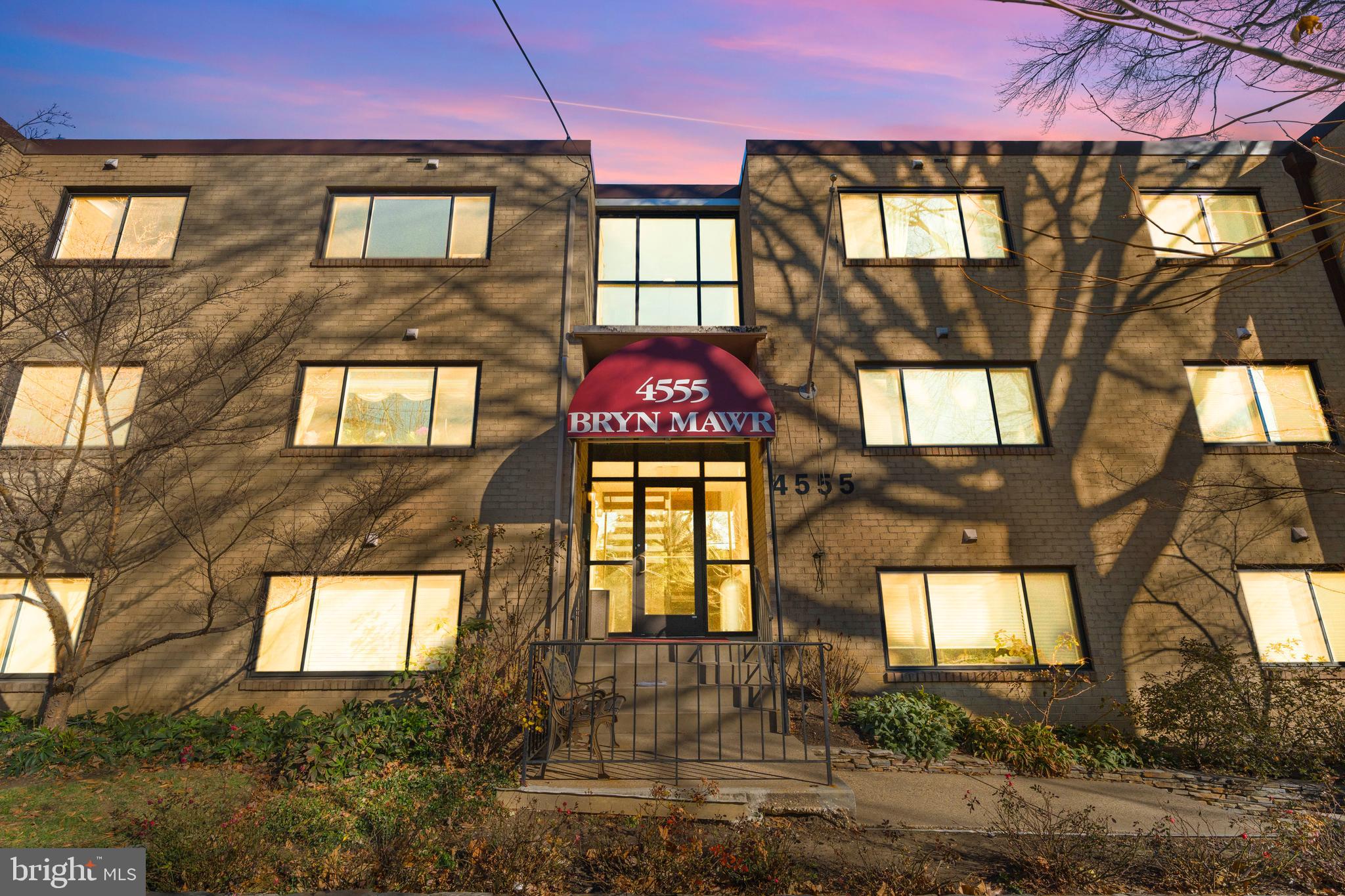4555 MacArthur Boulevard Northwest, Unit 202 Washington, DC 20007 - Photo 1 of 27 a front view of a residential apartment building with a yard
