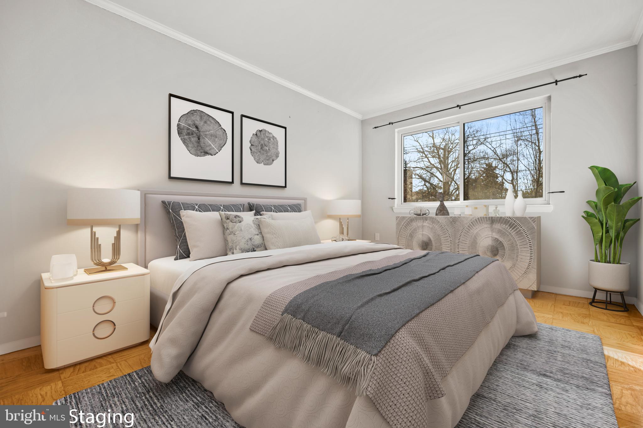 4555 MacArthur Boulevard Northwest, Unit 202 Washington, DC 20007 - Photo 13 of 27 a bedroom with bed and a painting on the wall