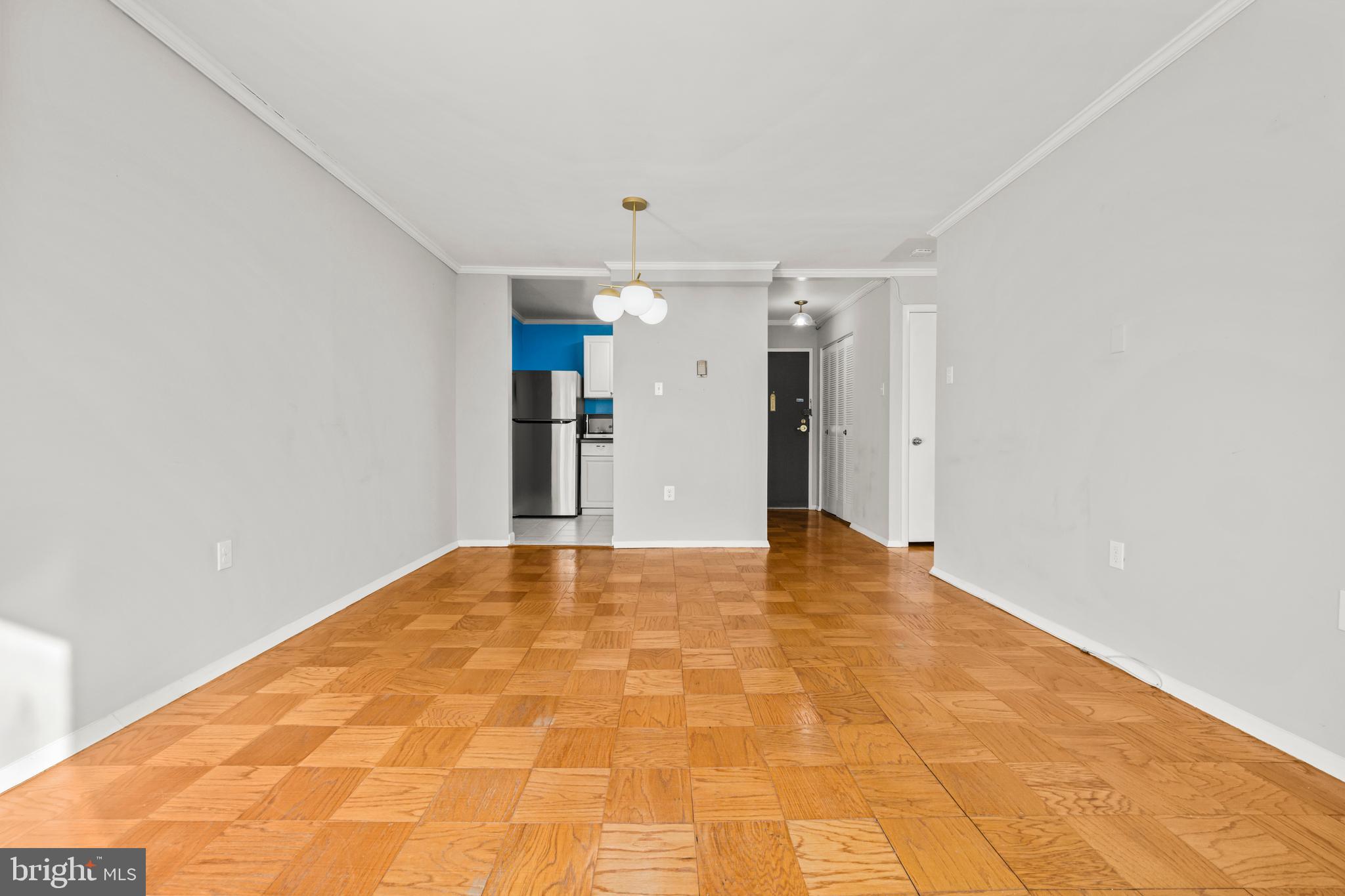 4555 MacArthur Boulevard Northwest, Unit 202 Washington, DC 20007 - Photo 5 of 27 a view of an empty room with chandelier and a window