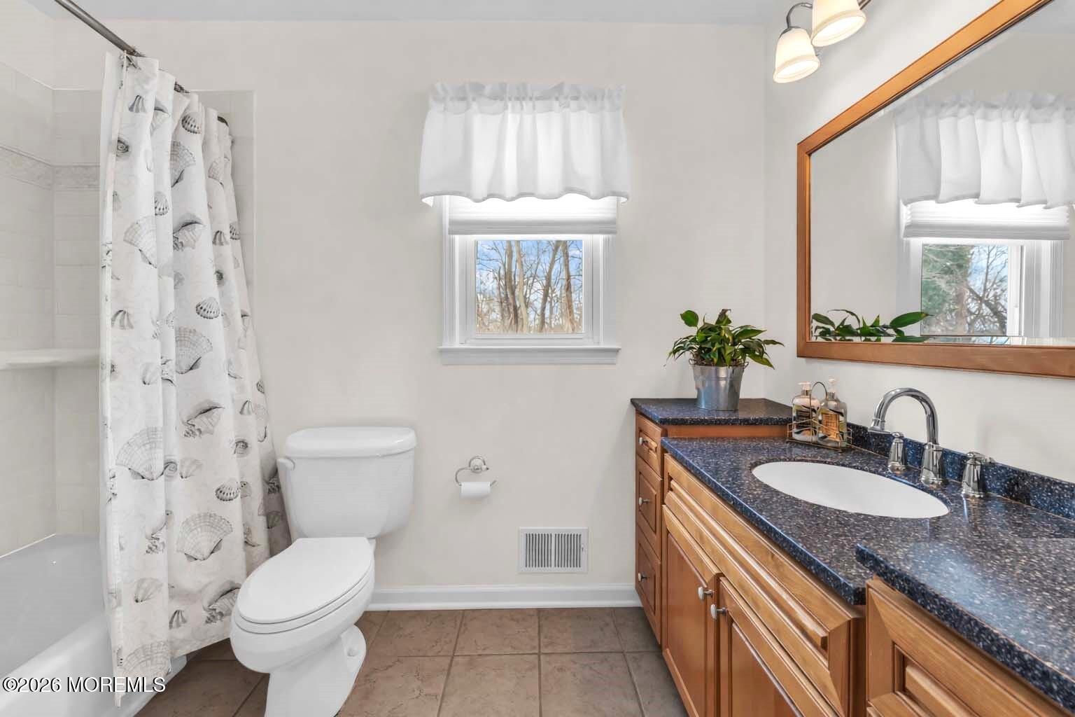 9 Johnny Court Red Bank, NJ 07701 - Photo 33 of 69 a bathroom with a granite countertop toilet a sink a mirror a window and vanity