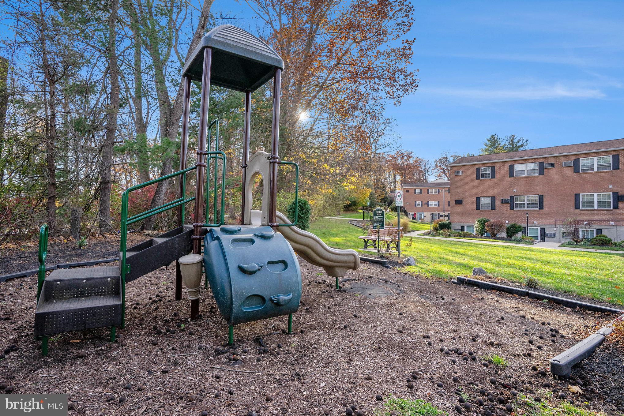 207 Walnut Hill Road, Unit B4 West Chester, PA 19382 - Photo 31 of 35 a view of a chairs in a backyard with large tree