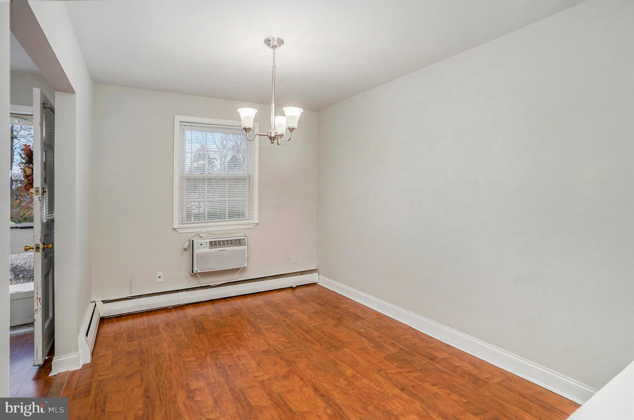 207 Walnut Hill Road, Unit B4 West Chester, PA 19382 - Photo 10 of 35 an empty room with chandelier fan and windows
