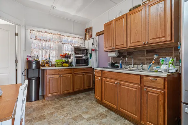 a kitchen with refrigerator and cabinets