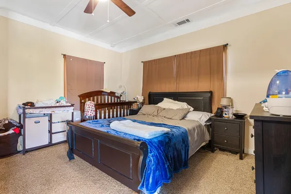 a bedroom with a large bed and a walk in closet