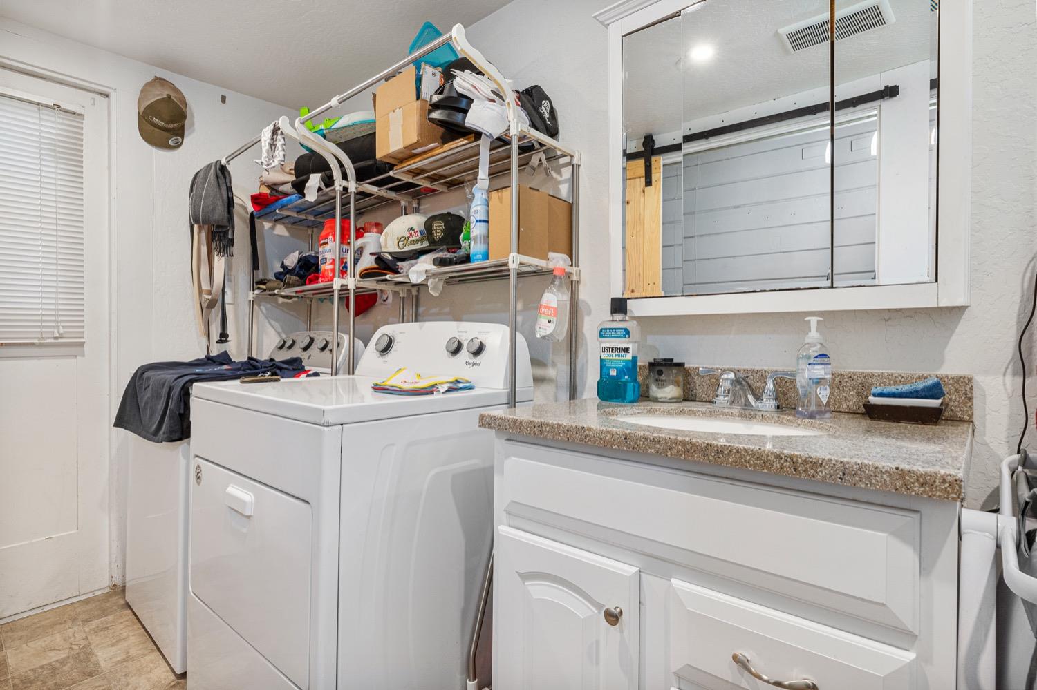 3724 Lockwood Road Ceres, CA 95307 - Photo 18 of 18 a utility room with stainless steel appliances granite countertop a sink and cabinets