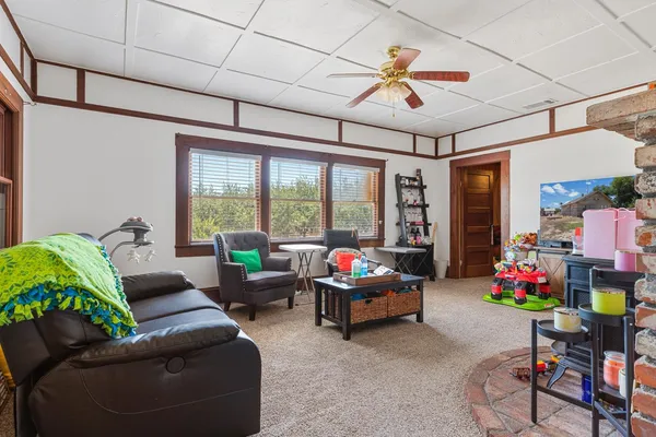 a living room with furniture gym equipment and a chandelier