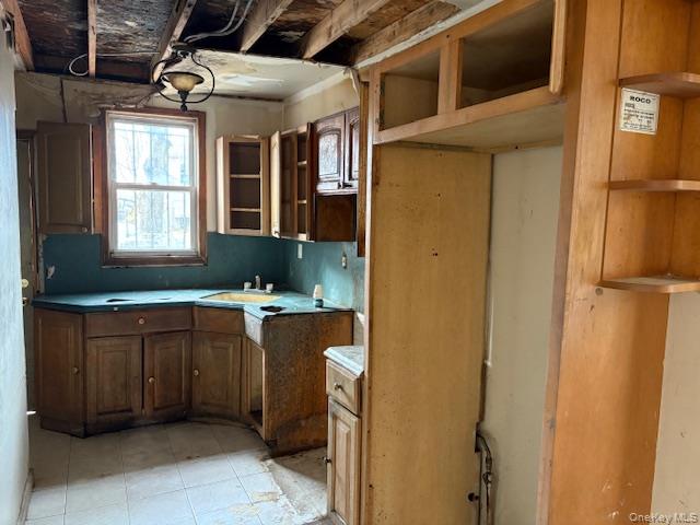 114-06 167th Street Queens, NY 11434 - Photo 13 of 23 Kitchen featuring brown cabinetry and a sink