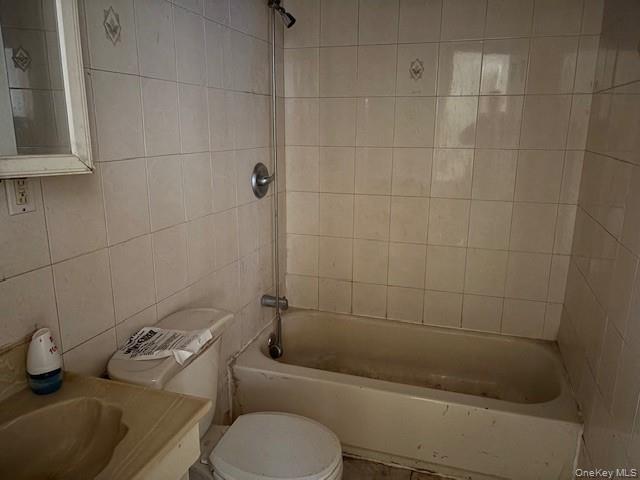 114-06 167th Street Queens, NY 11434 - Photo 22 of 23 Bathroom featuring tile walls, shower combination, and vanity