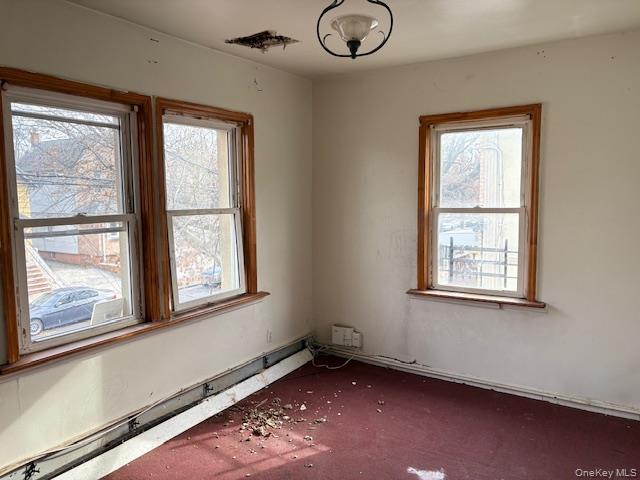 114-06 167th Street Queens, NY 11434 - Photo 6 of 23 Carpeted empty room with a baseboard radiator