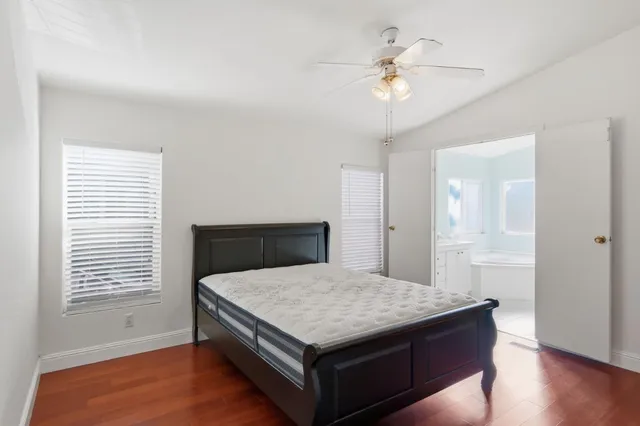 a living room with a bed furniture and a chandelier