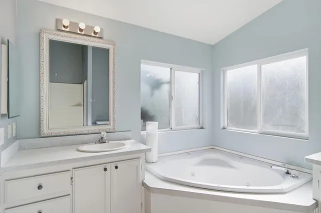 a bathroom with a bathtub and a sink