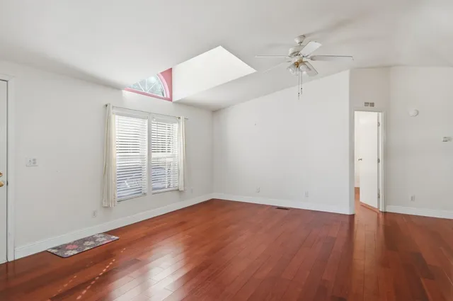 wooden floor in an empty room with a window