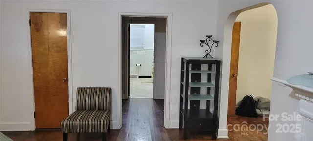 a kitchen with a refrigerator a stove and wooden floor