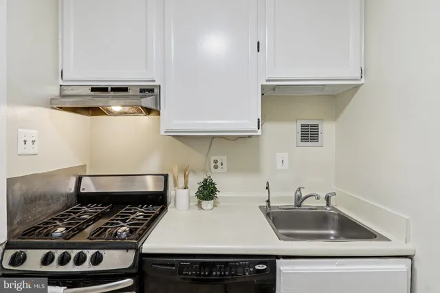 a view of a room with mirror and furniture