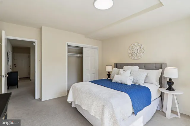 a bedroom with a bed and painting on the wall