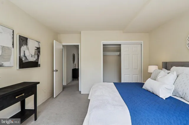 a bedroom with a bed and glass window