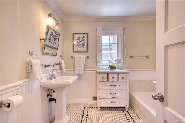 a bathroom with a sink a mirror and a bathtub