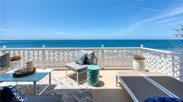 a kitchen with a stove a sink wooden floor and cabinets