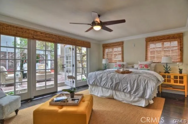 a spacious bedroom with a bed and glass window