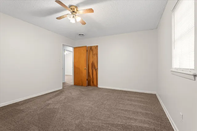 a white house that has a tree in front of it