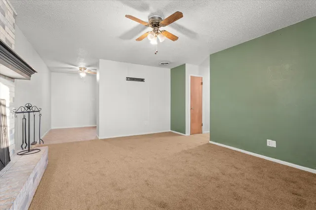 a view of a livingroom with a chandelier fan