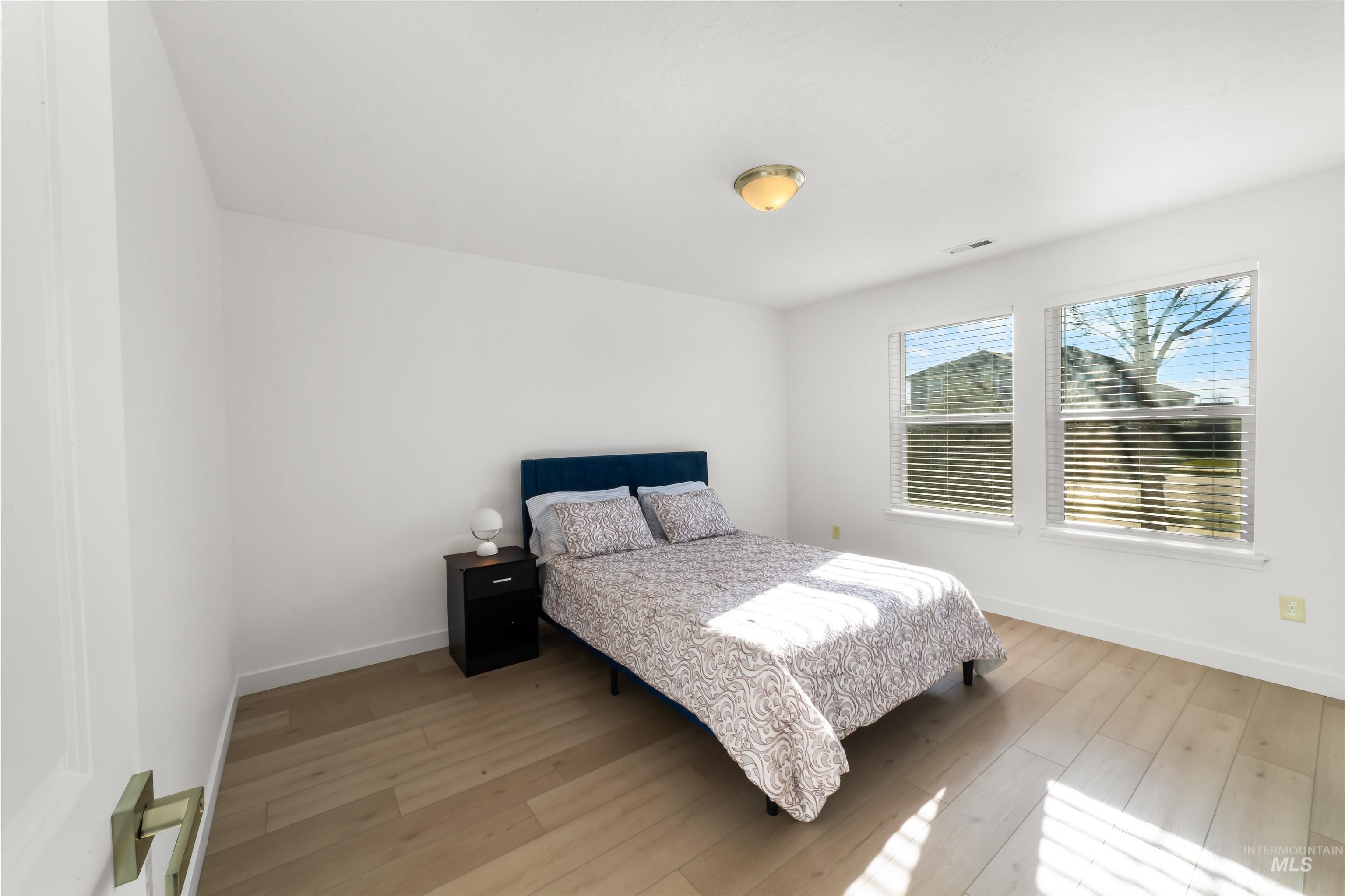 548 North Ripplerock Place Star, ID 83669 - Photo 11 of 42 Bedroom with light wood finished floors and baseboards