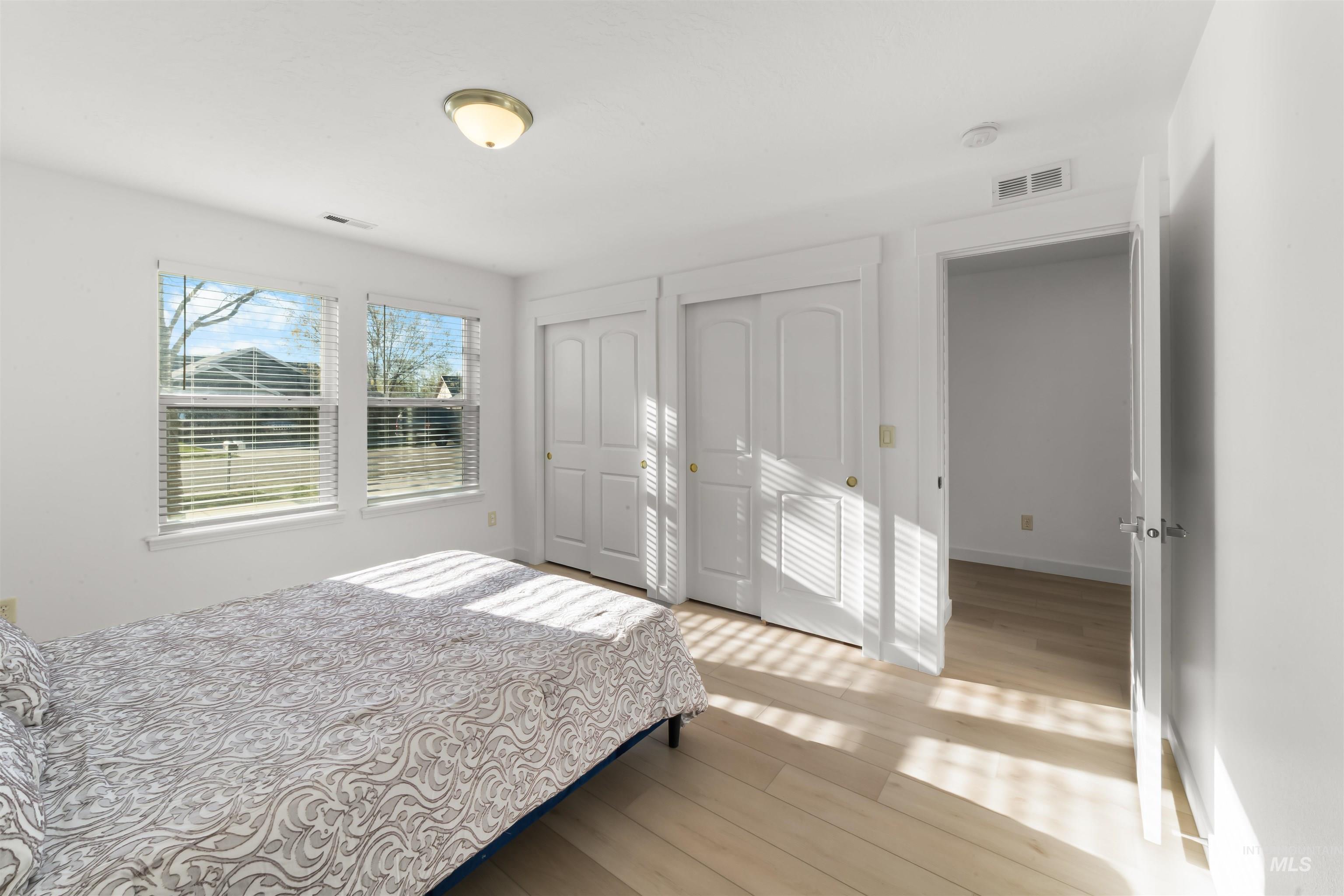 548 North Ripplerock Place Star, ID 83669 - Photo 12 of 42 Bedroom with two closets and light wood-type flooring