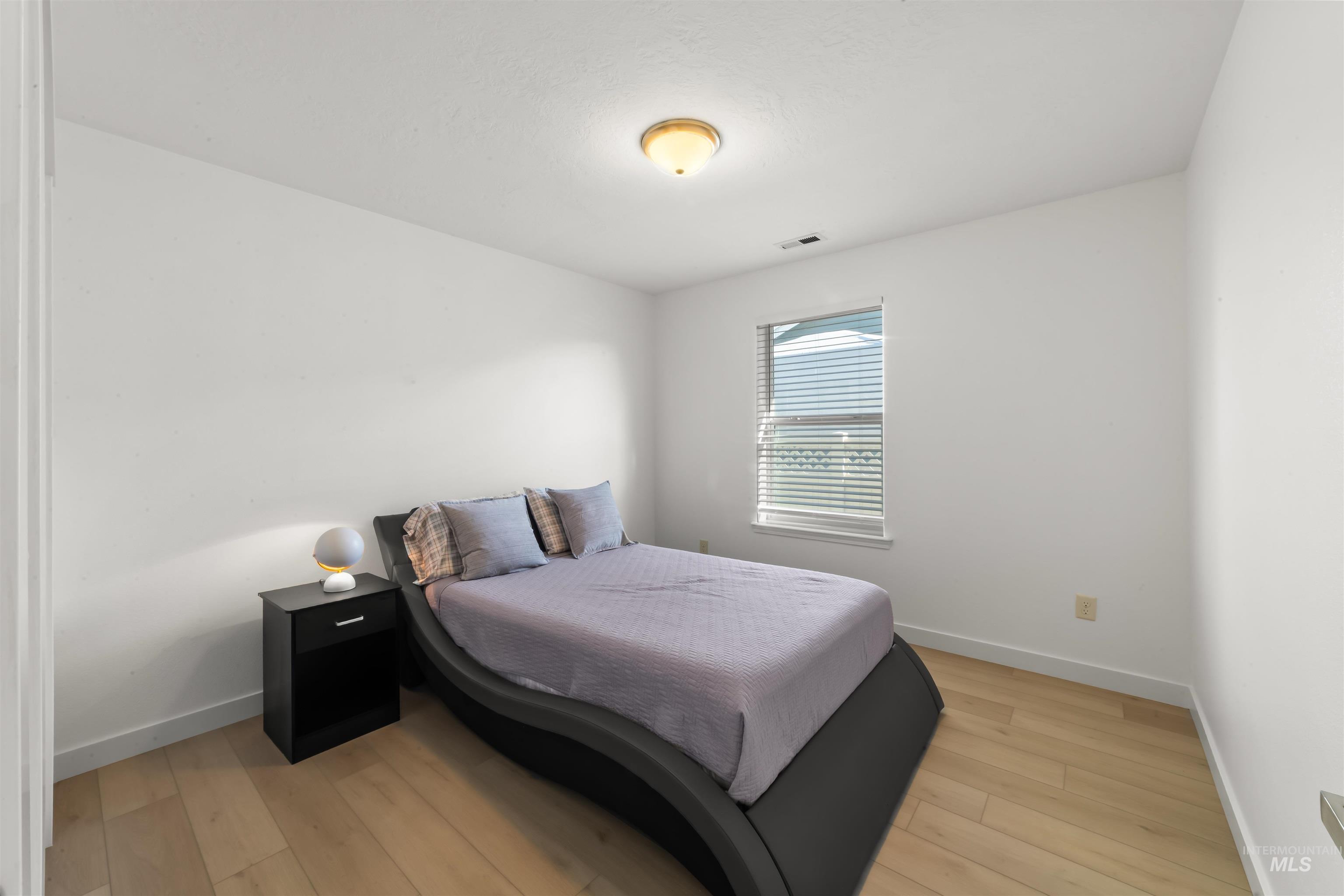 548 North Ripplerock Place Star, ID 83669 - Photo 14 of 42 Bedroom with light wood-type flooring