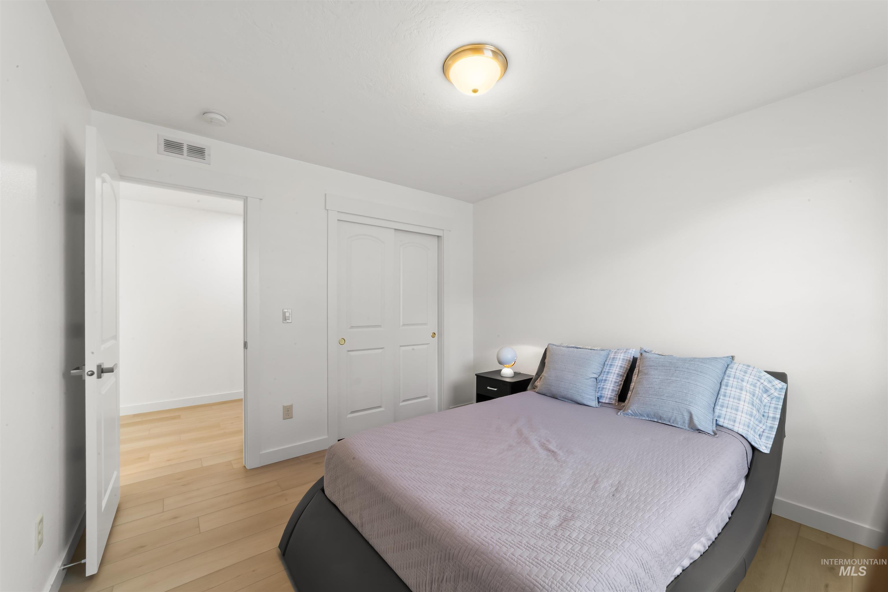 548 North Ripplerock Place Star, ID 83669 - Photo 15 of 42 Bedroom featuring light wood-style floors and a closet