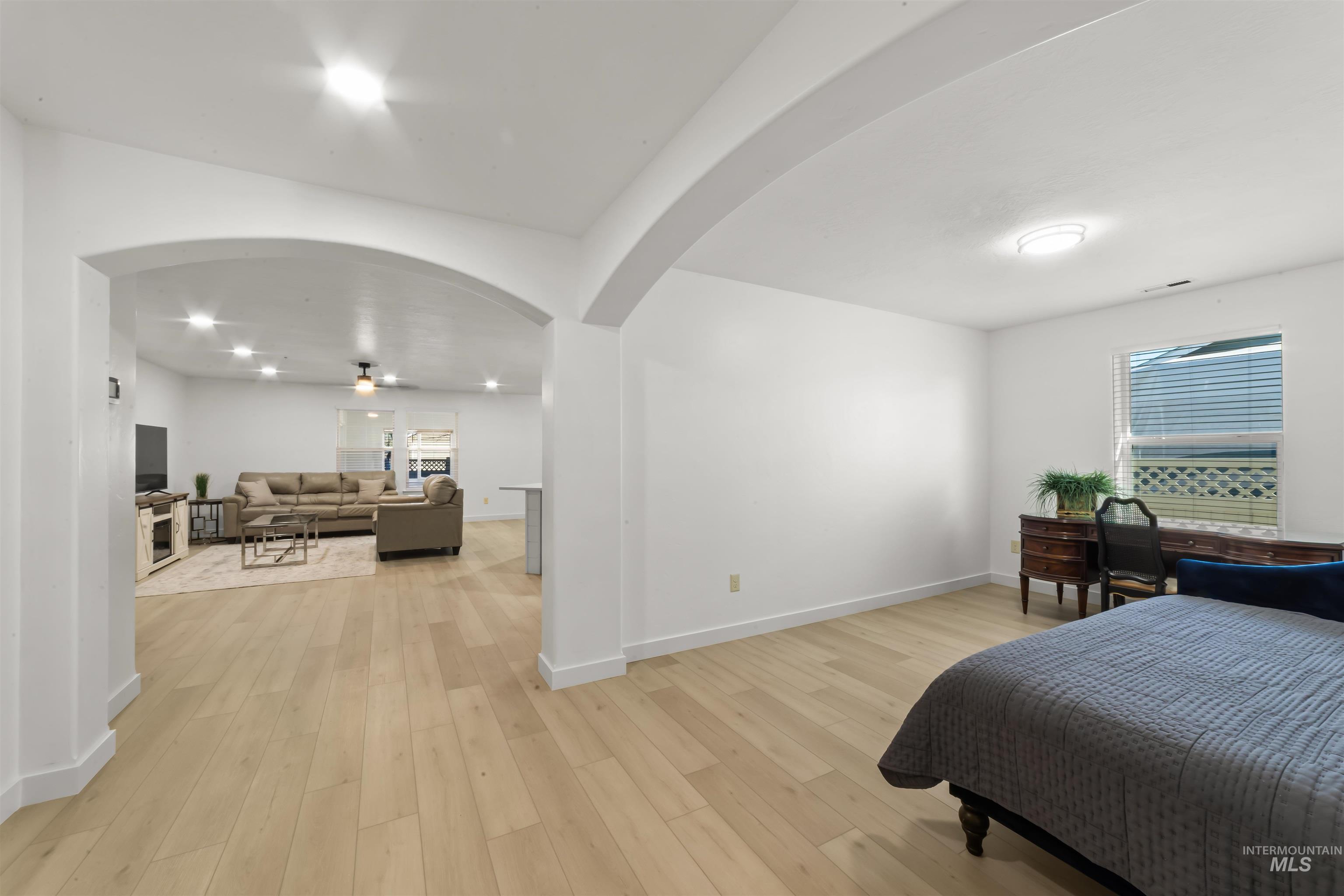 548 North Ripplerock Place Star, ID 83669 - Photo 17 of 42 Bedroom featuring light wood finished floors and arched walkways