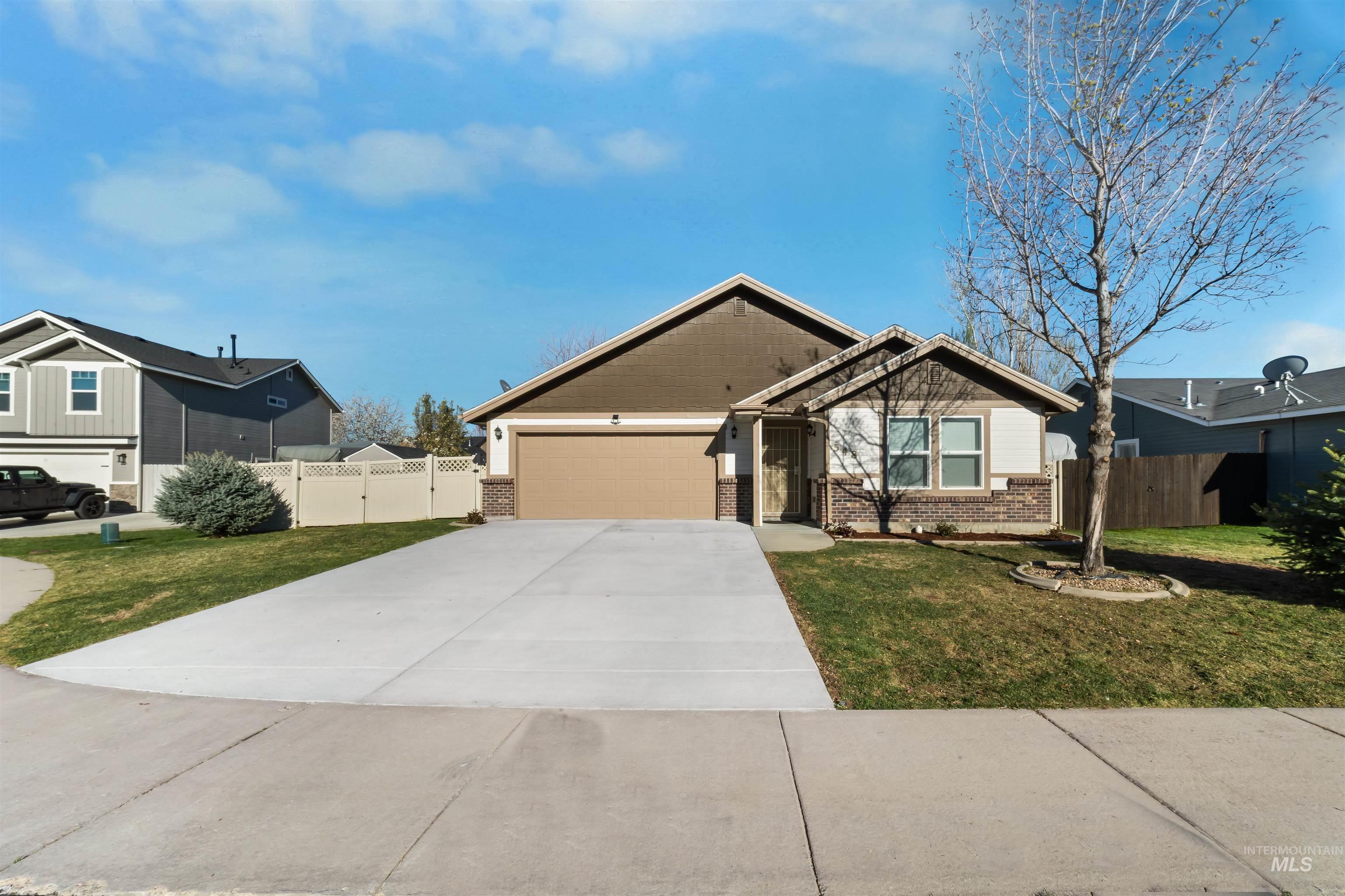548 North Ripplerock Place Star, ID 83669 - Photo 2 of 42 Craftsman house featuring concrete driveway, an attached garage, brick siding, and a gate