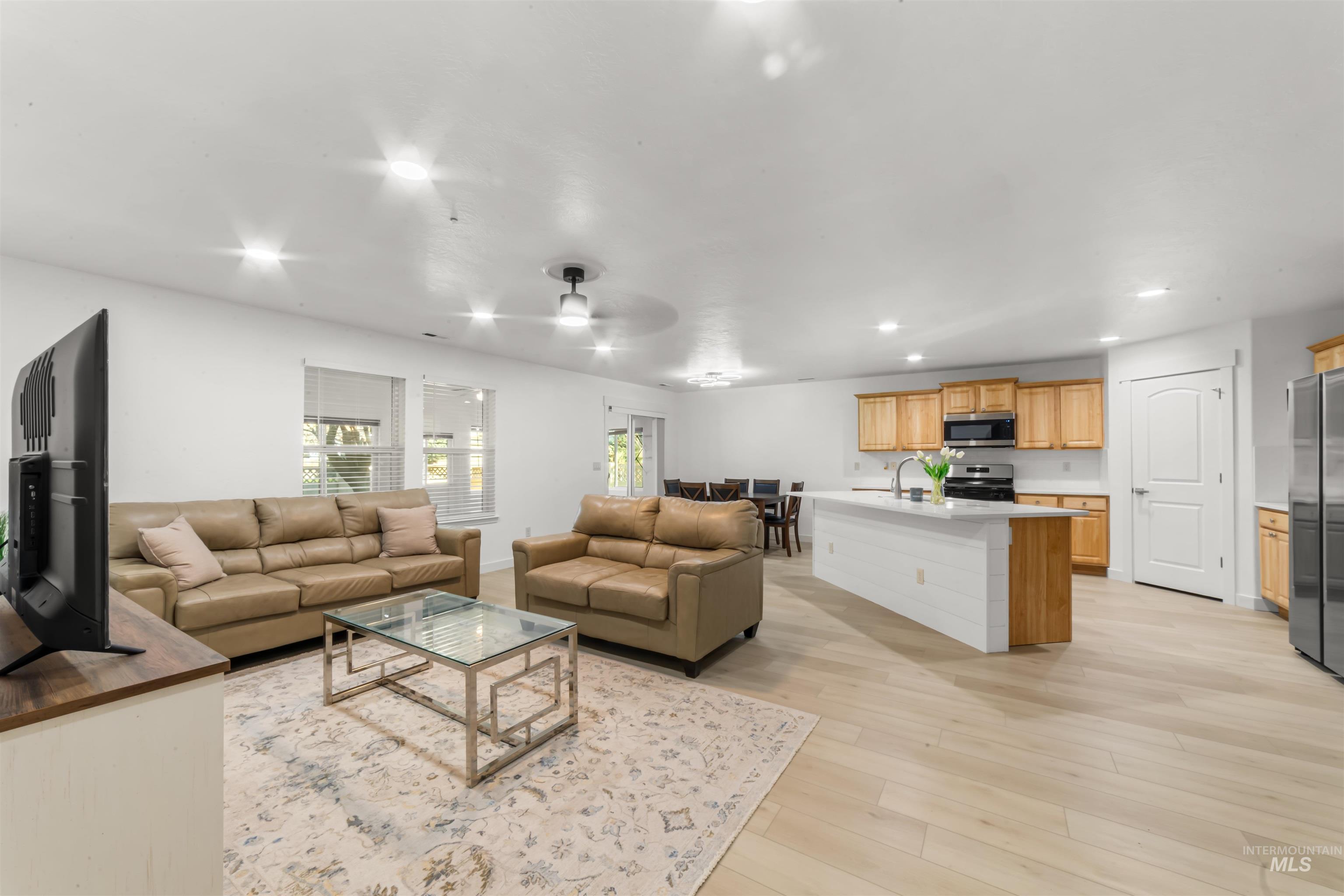 548 North Ripplerock Place Star, ID 83669 - Photo 24 of 42 Living room featuring recessed lighting, a ceiling fan, and light wood-style floors