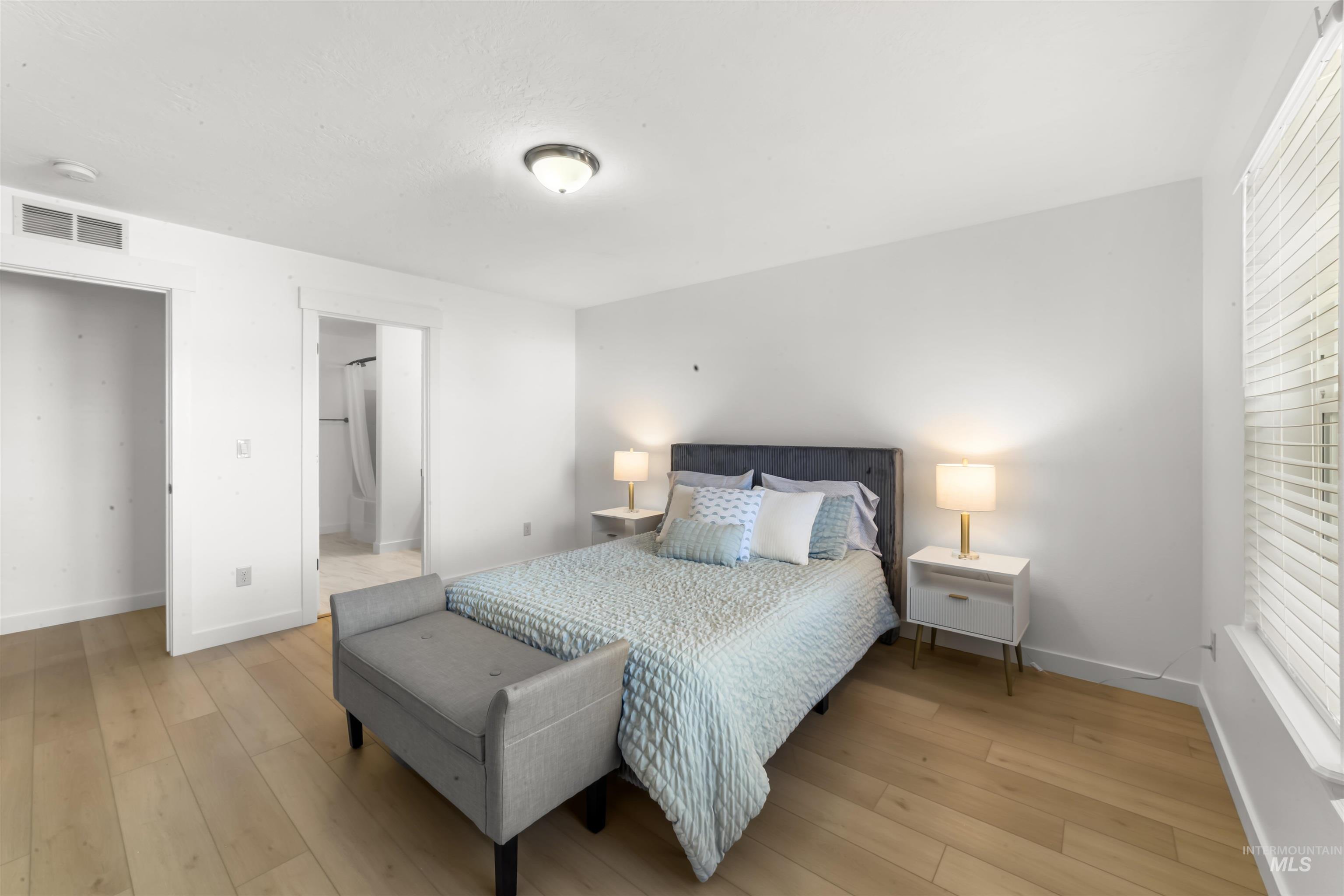 548 North Ripplerock Place Star, ID 83669 - Photo 27 of 42 Bedroom featuring light wood-style floors and connected bathroom