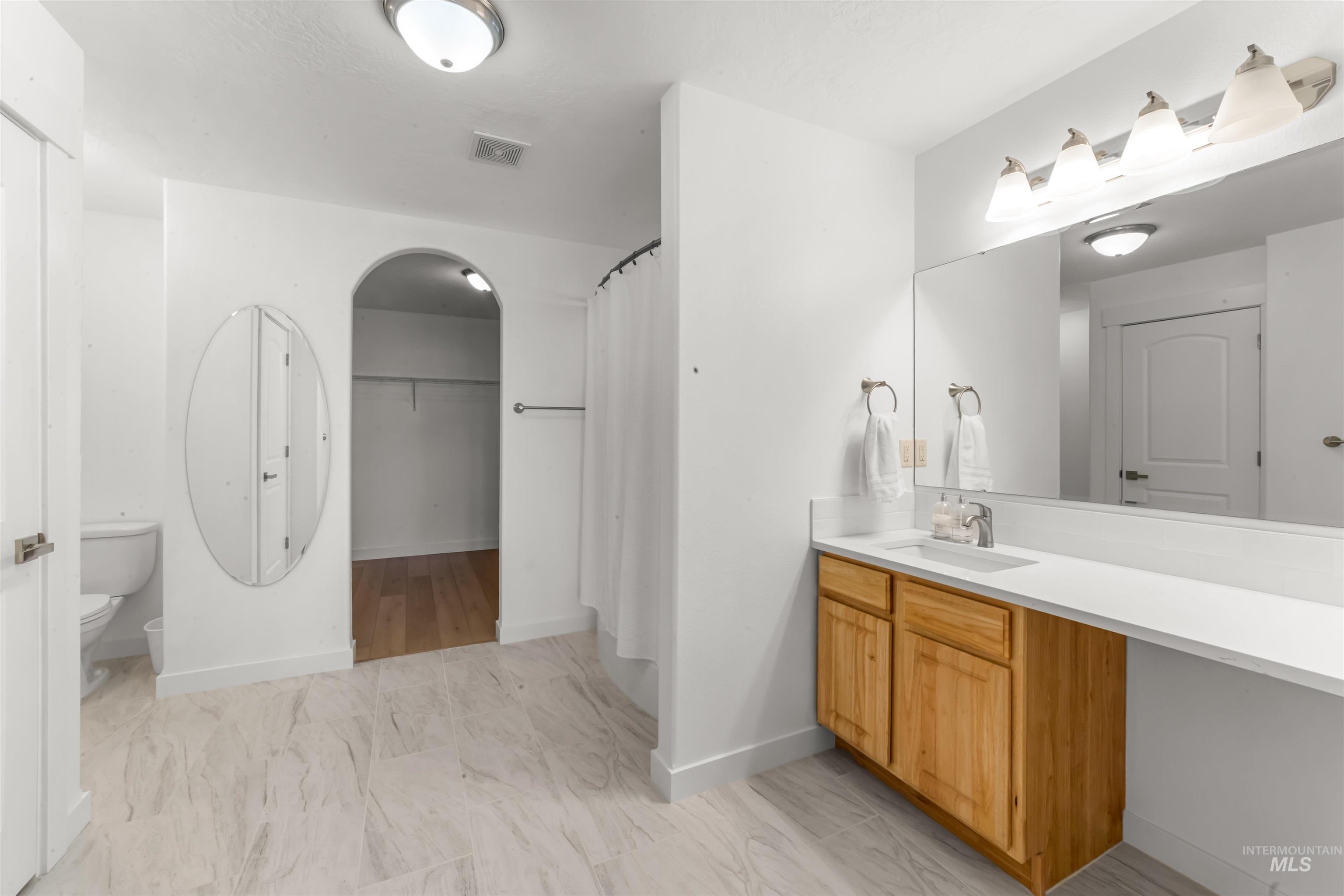 548 North Ripplerock Place Star, ID 83669 - Photo 28 of 42 Full bath featuring vanity, a spacious closet, and a shower with curtain