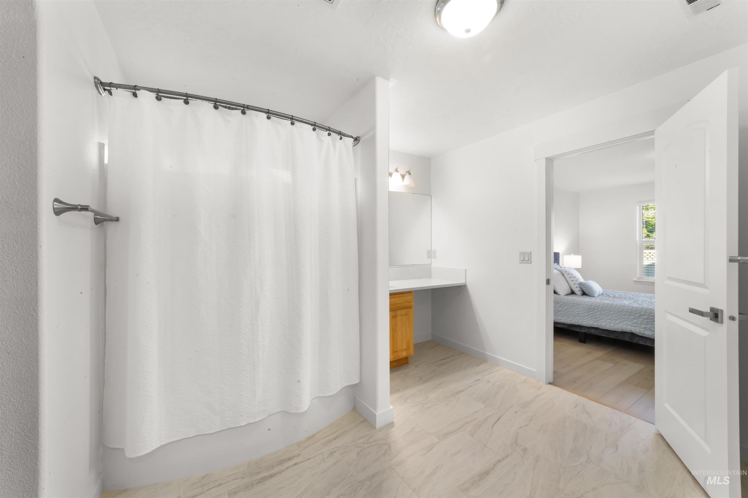 548 North Ripplerock Place Star, ID 83669 - Photo 32 of 42 Full bath featuring ensuite bath, a shower with curtain, light marble finish flooring, and vanity