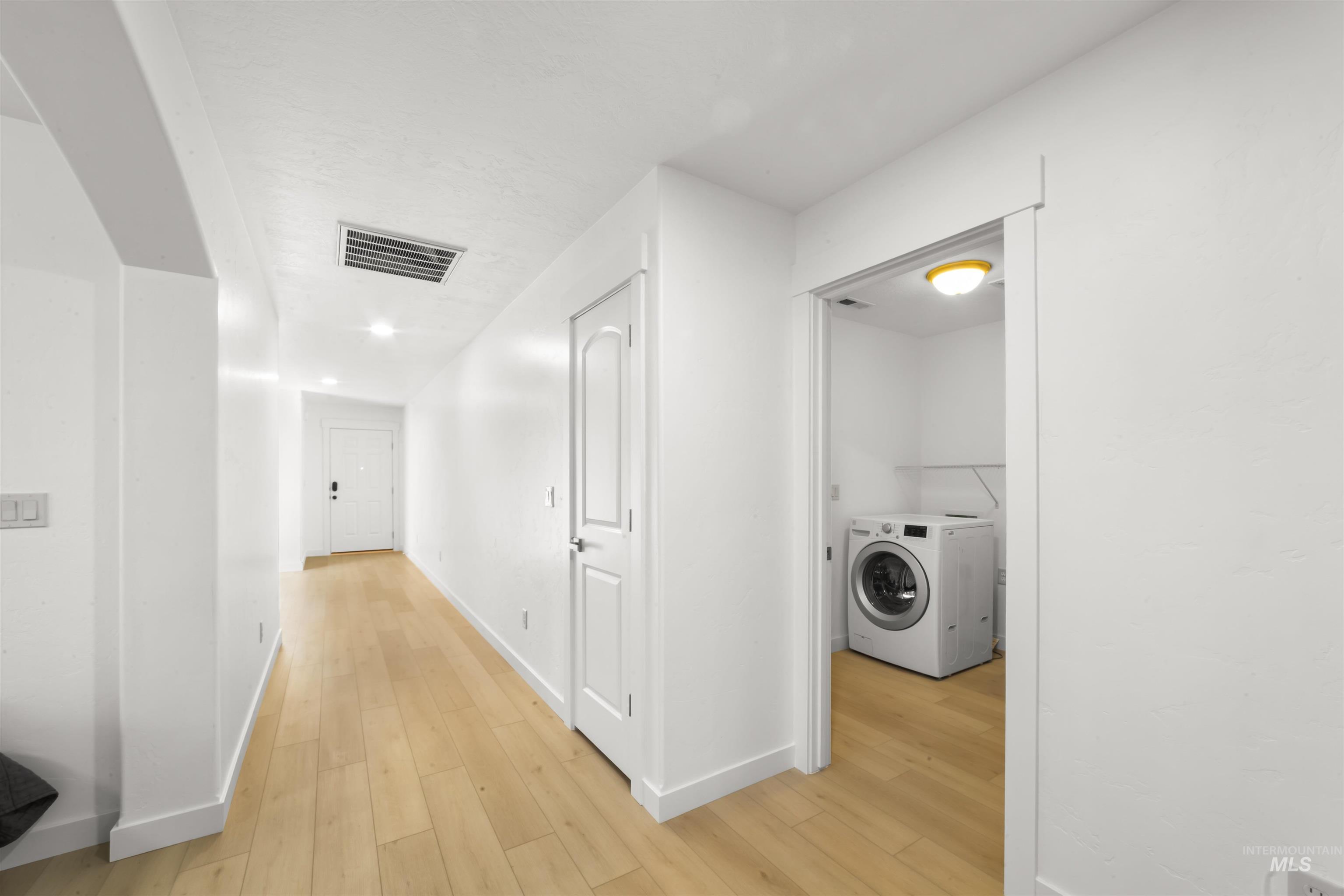 548 North Ripplerock Place Star, ID 83669 - Photo 34 of 42 Hallway with washer / dryer, light wood-type flooring, and recessed lighting