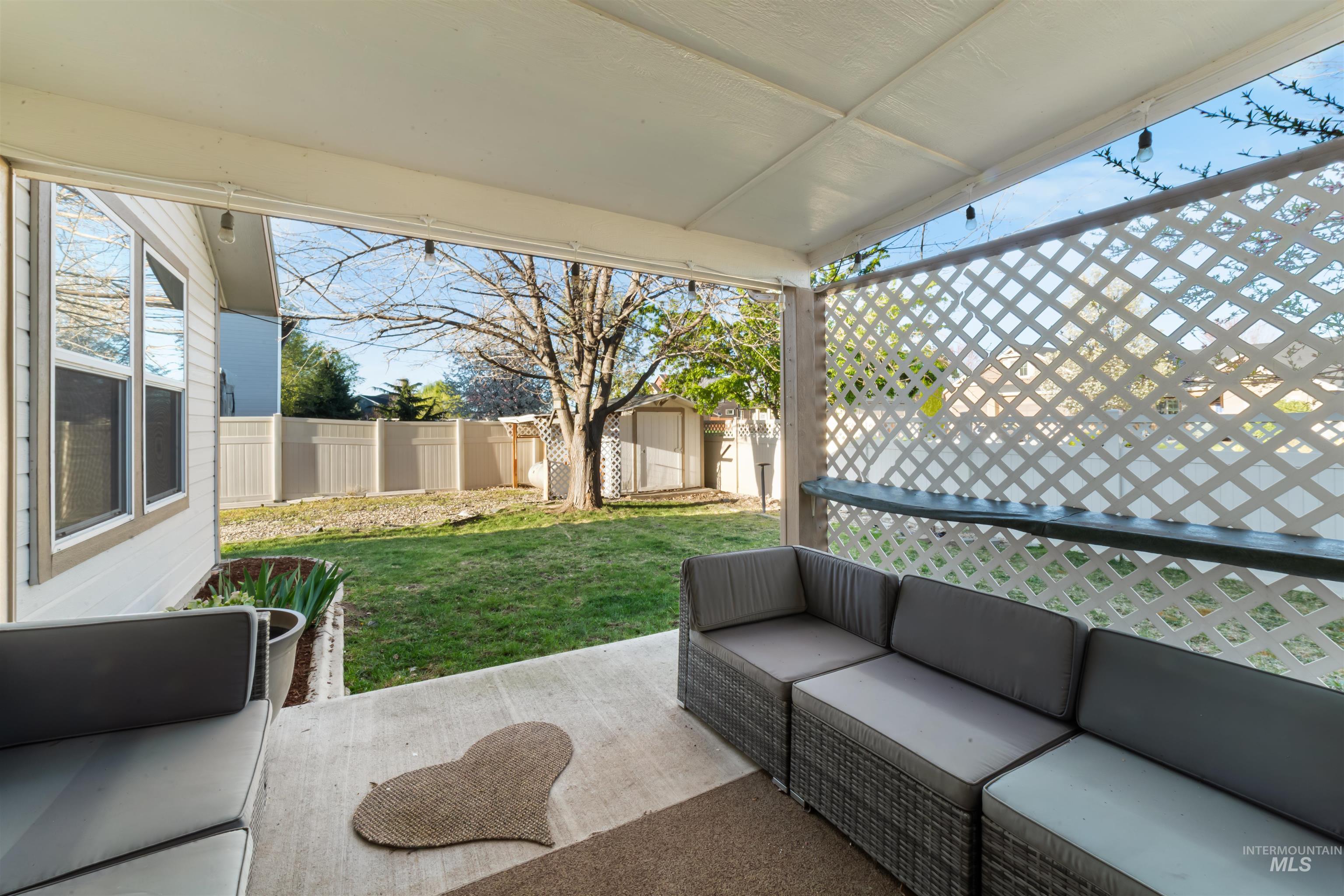 548 North Ripplerock Place Star, ID 83669 - Photo 37 of 42 Fenced backyard with a patio area, outdoor furniture, and a storage shed