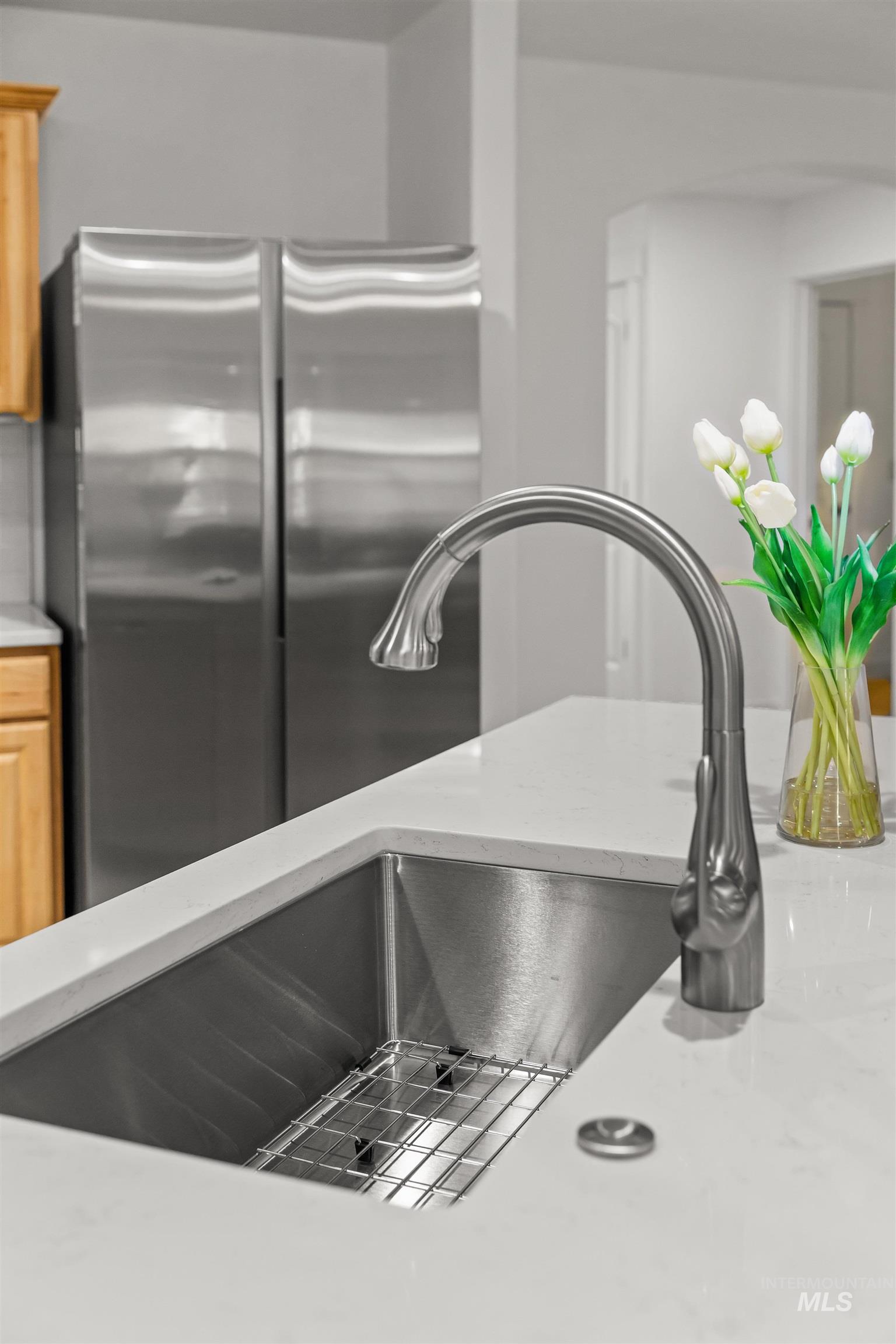 548 North Ripplerock Place Star, ID 83669 - Photo 41 of 42 Kitchen view of freestanding refrigerator and light stone countertops