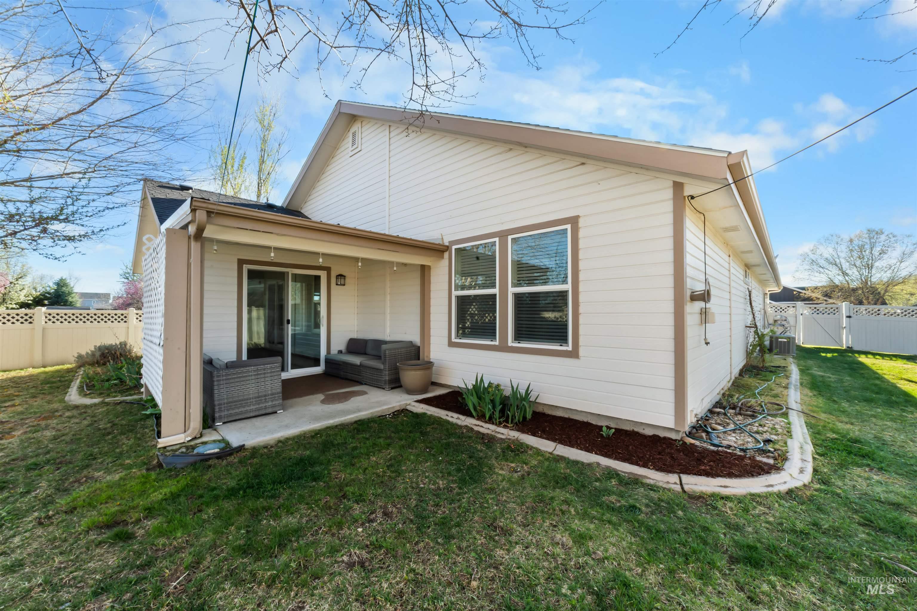 548 North Ripplerock Place Star, ID 83669 - Photo 7 of 42 Rear view of house with a fenced backyard, a patio area, and a gate