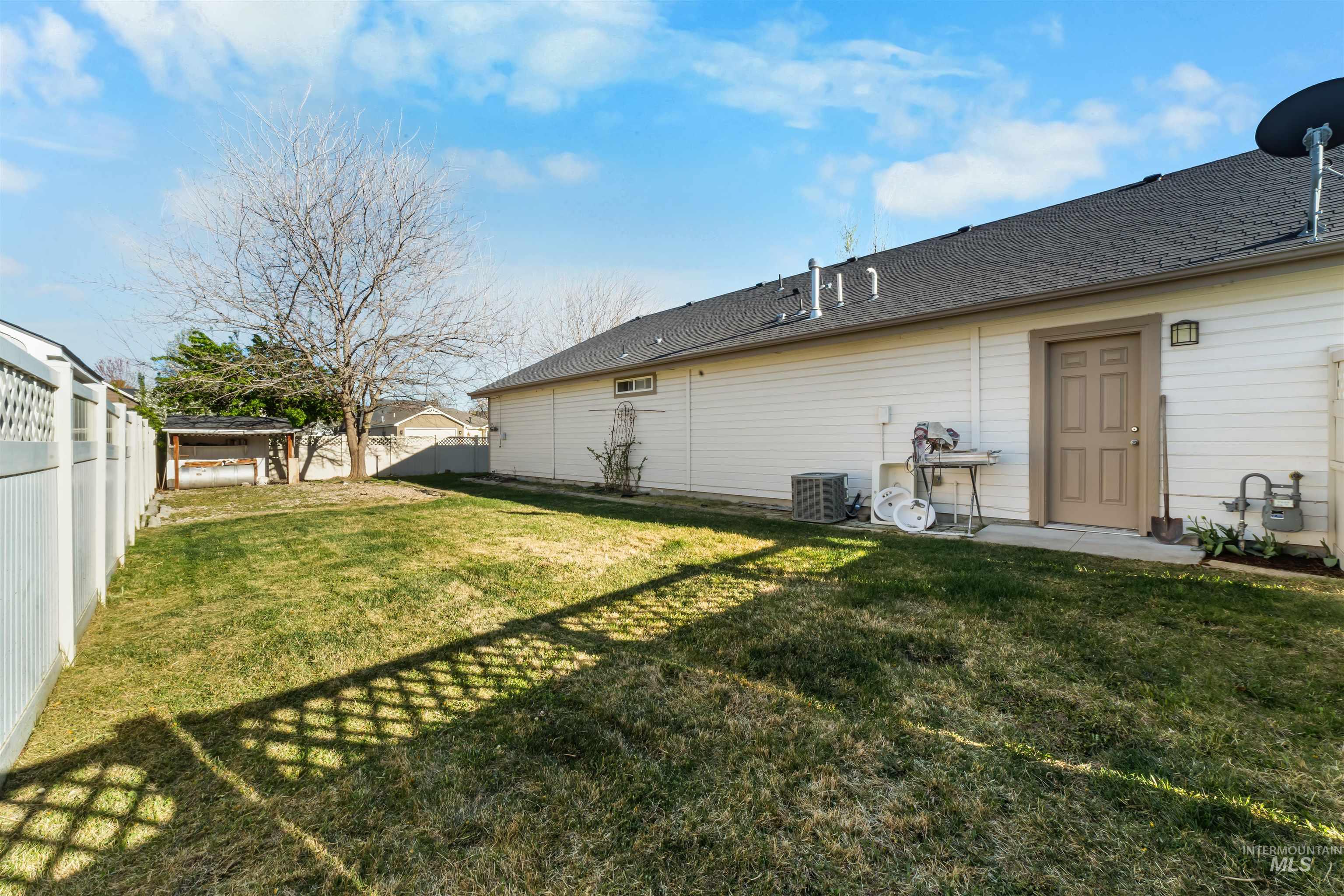 548 North Ripplerock Place Star, ID 83669 - Photo 8 of 42 Back of house featuring a patio area, a fenced backyard, and a shingled roof