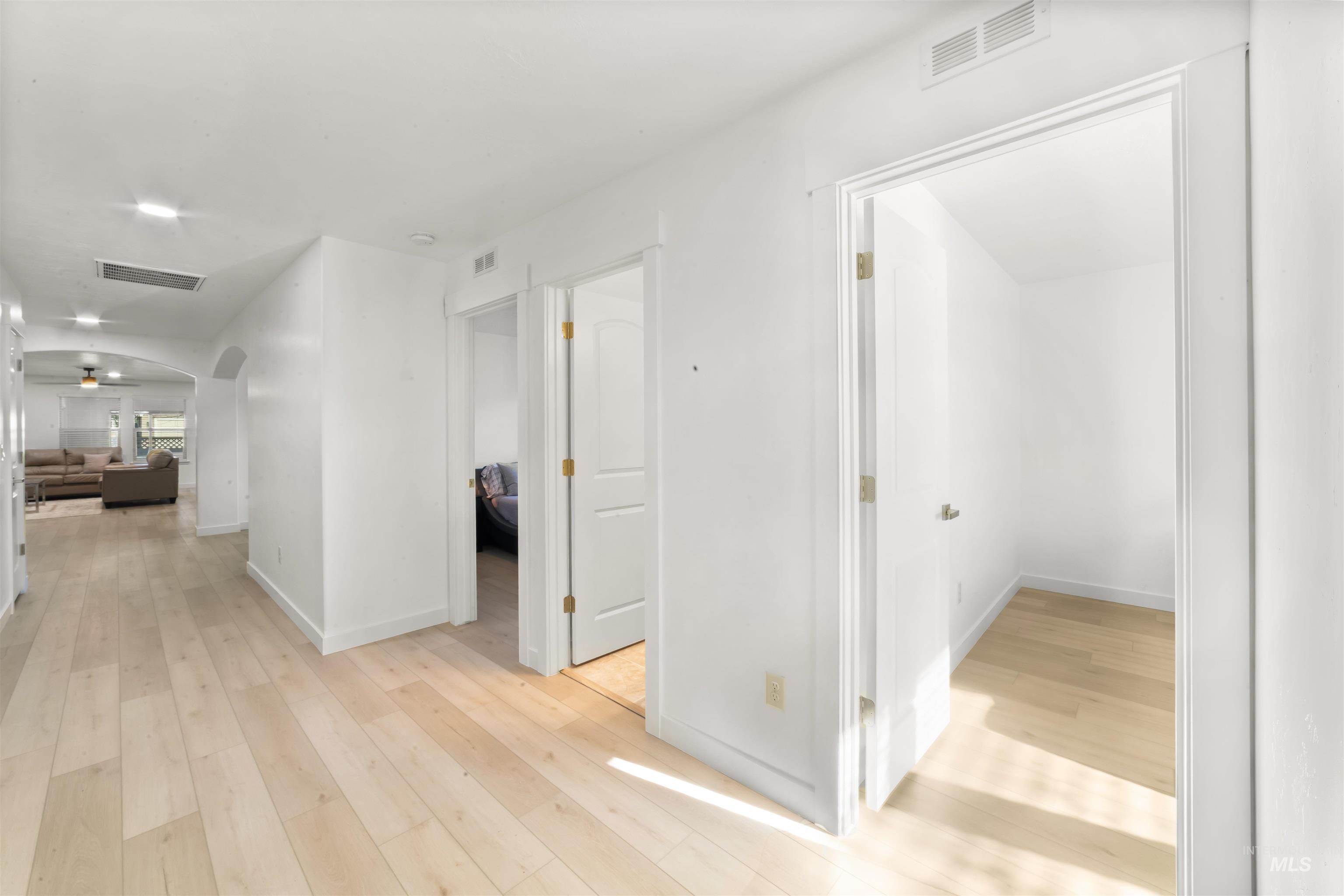 548 North Ripplerock Place Star, ID 83669 - Photo 10 of 42 Hallway with light wood-style flooring and arched walkways