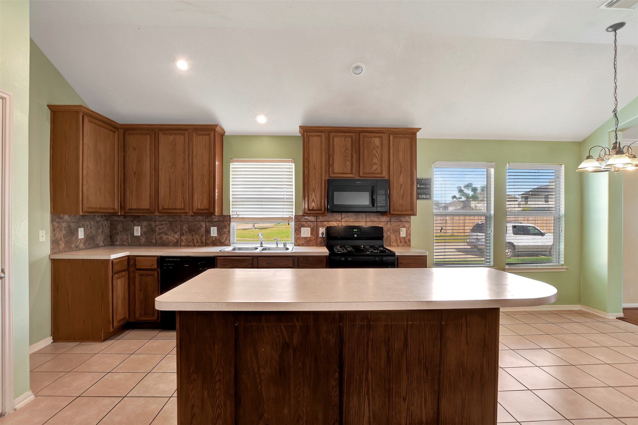 5918 Durango Mist Lane Katy, TX 77449 - Photo 11 of 41 a kitchen with a sink a stove a refrigerator and cabinets
