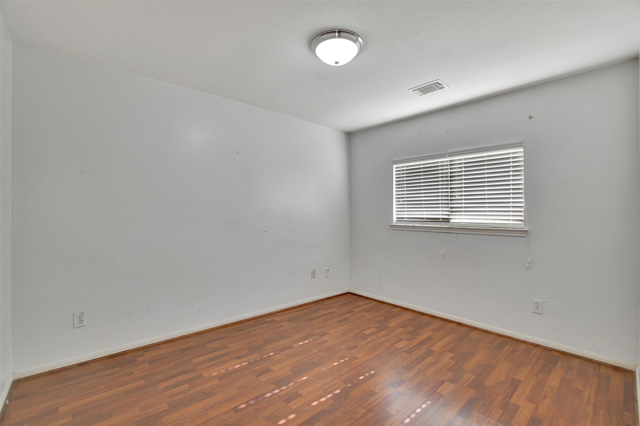 5918 Durango Mist Lane Katy, TX 77449 - Photo 12 of 41 an empty room with wooden floor and windows