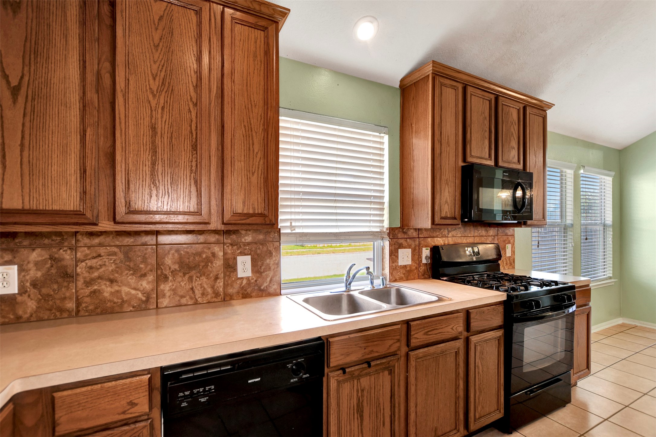 5918 Durango Mist Lane Katy, TX 77449 - Photo 15 of 41 a kitchen with stainless steel appliances a sink dishwasher stove and cabinets
